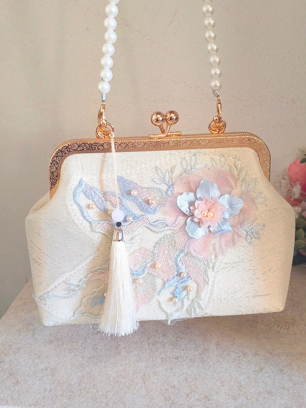 Pochette in seta con ricamo floreale pastello, borsa a mano con perle e nappa