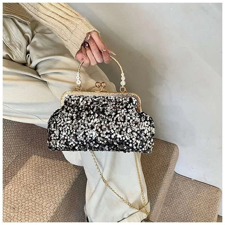 Pochette da sera ricoperta di paillettes brillanti con manico dorato