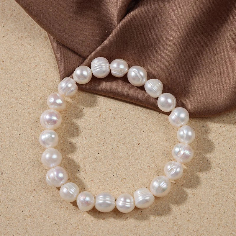 Elastisches Armband mit natürlichen Süßwasserperlen 9mm „Milchiger Pfirsich“