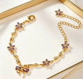 Bracciale regolabile con fiocco e fiore color oro e zirconi con cristalli