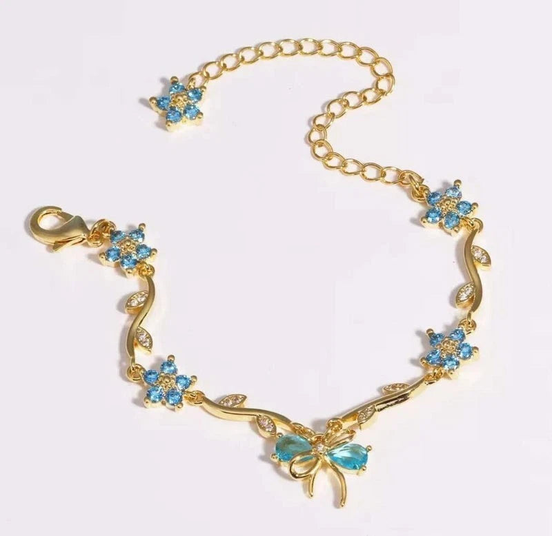 Bracciale regolabile con fiocco e fiore color oro e zirconi con cristalli