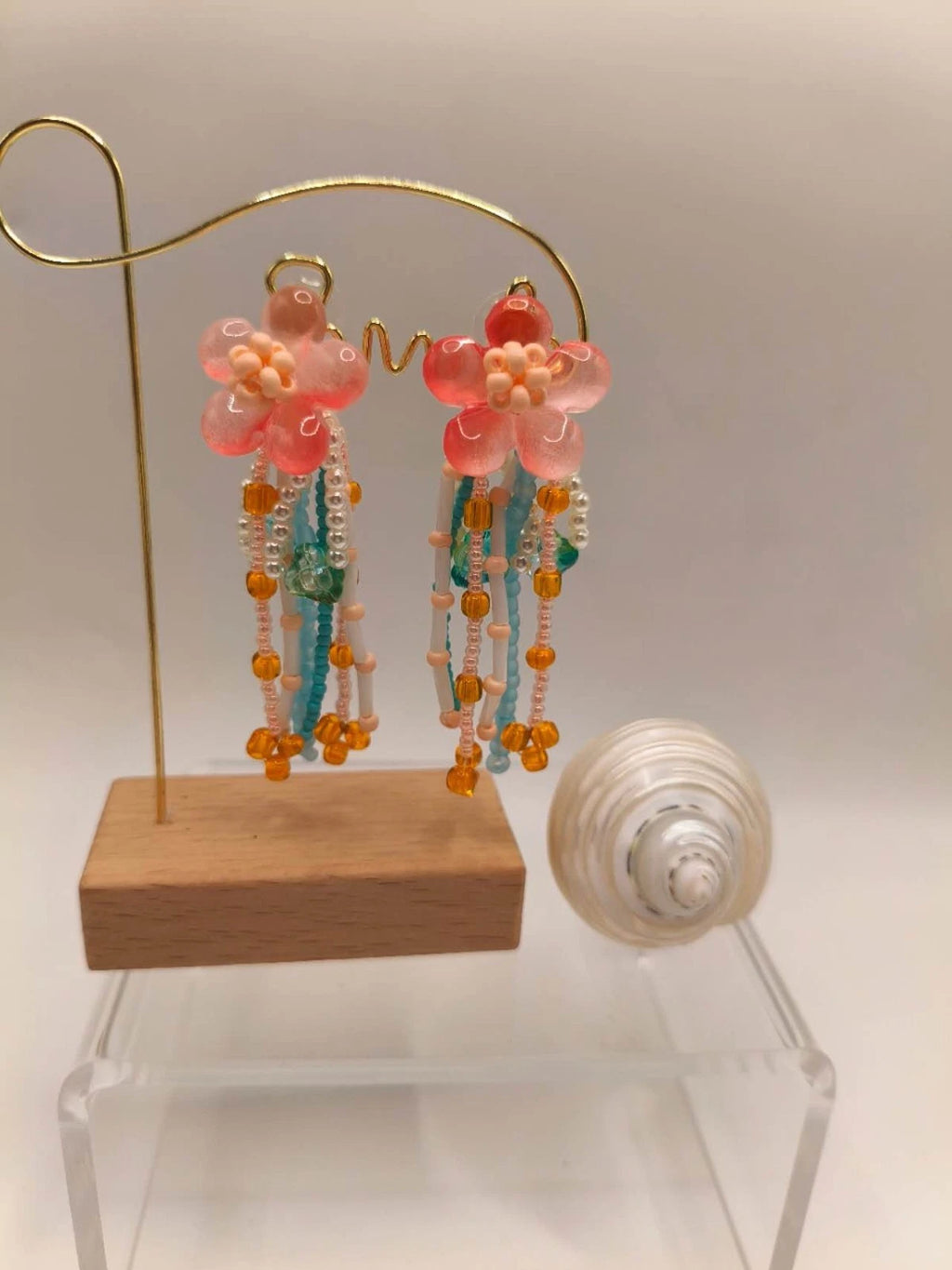 Handgefertigte Ohrringe mit Naturperlen und Kunstharz mit Blumenmotiven und Quasten